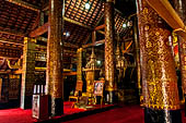 Wat Xieng Thong temple in Luang Prabang, Laos. The sim s interior is extensively decorated with intricate gold stencilling on black lacquer. Large stencilled teak wood pillars support the roof.  